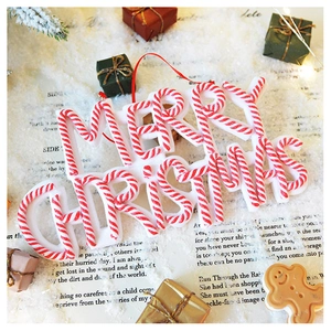 Red and white Merry Christmas letter plaque ornament with festive holiday decor