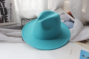 Detail of tiffany blue fedora wool hat with wide brim in a soft studio setting