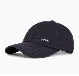 Detail of navy blue cotton baseball cap featuring a premium metal angler fashion logo