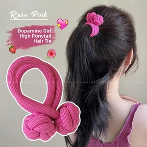 Detail of rose pink elastic hair tie with textured knit and woven ball knots