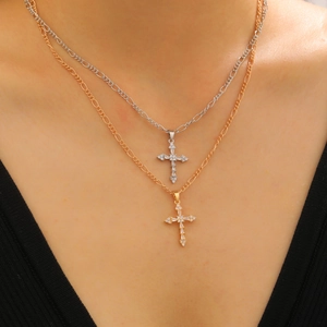 Gold and silver cross pendant necklace with cubic zirconia inlays on a stylish box chain