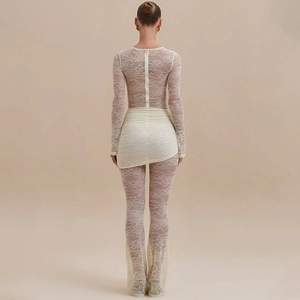 Detailed back view of white lace bodysuit with long sleeves and elegant draped fabric