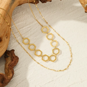 French vintage double-layered golden geometric hexagon necklace on driftwood