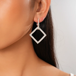 Close-up of elegant square drop earrings with silver plating and cubic zirconia stones