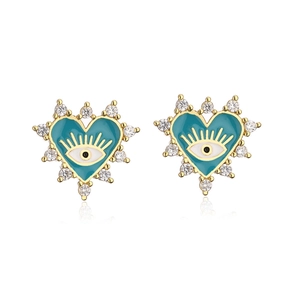 Close-up of gold plated heart-shaped evil eye stud earrings with blue enamel and zircons