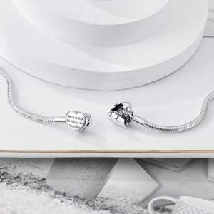 Macro detail of silver heart clasp with With GOD All things are Possible engraving