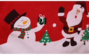 Close-up of festive Santa and snowman printed patterns on red non-woven chair cover