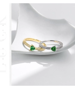 Macro detail of S925 sterling silver stamp on green heart gemstone rings with pavé diamonds