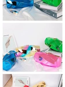 Detailed close-up of geometric acrylic evening clutch bags in metallic rainbow finishes