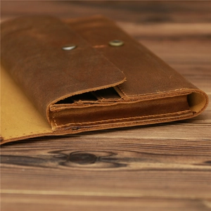 Macro shot of vintage brown crazy horse leather wallet with multi-layer accordion folds