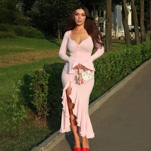 Detail of pink V-neck dress featuring button front, ruffled cuffs, and a high side slit