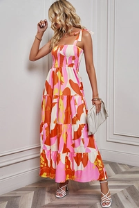 Close-up of the smocked elastic bodice and tie-up shoulder straps on the floral maxi dress