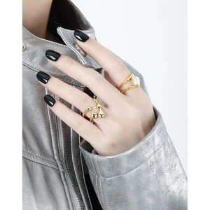 Irregular liquid style gold ring set with pearls on hand in minimalist fashion style