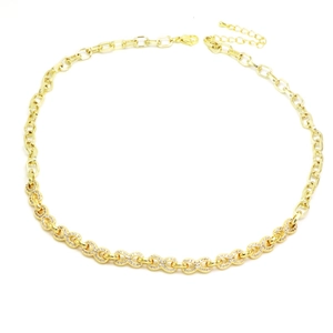 Detailed view of golden infinity link necklace with pavé cubic zirconia accents
