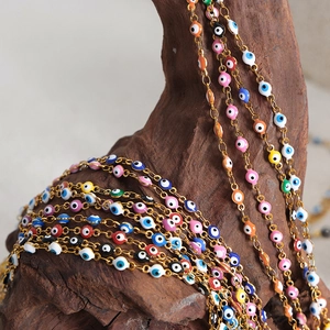 Exotic evil eye titanium steel necklaces with colorful enamel charms on driftwood
