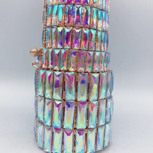 Detailed close-up of a cylinder evening clutch featuring colorful rhinestones and rose gold frame