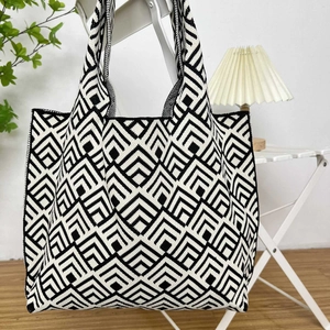 Detail of black and white geometric knit tote bag showing thick texture and large capacity