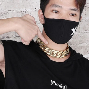 Close-up of a thick gold Cuban link chain necklace worn by a male model in hip-hop style