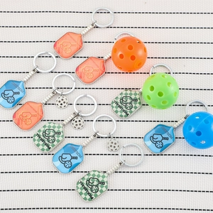 Pickleball paddle keychain set with 11 pieces in various colors and realistic ball charms