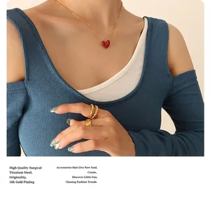 Detailed close-up of 18K gold plated titanium heart necklace and textured ring set
