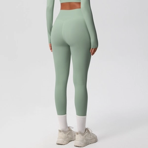 Rear view of mint green high-waisted yoga leggings with a tight fit and matte finish