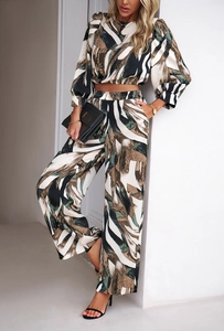 Detailed view of women's two-piece set featuring long-sleeve crop top and wide-leg trousers