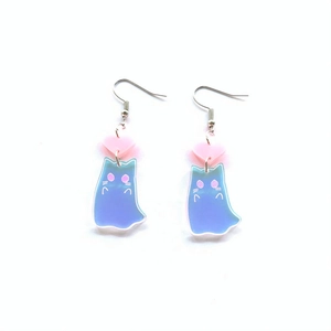 Detailed view of iridescent blue ghost cat acrylic earrings with pink heart charms