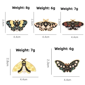 Exquisite enamel butterfly and moth brooches set with floral and moon motifs on white background