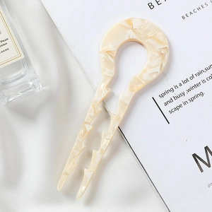 Detail of cream marble pattern U-shaped hair pin with anti-slip wavy design on silk fabric