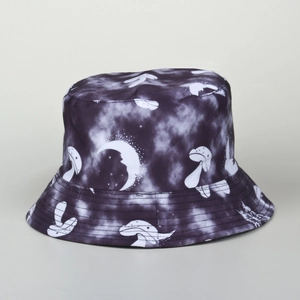 Detail of tie-dye bucket hat with white mushroom, moon, and stars illustration pattern