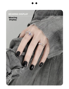 Close-up of S925 silver chain rings with colorful zircon inlay on model's hand