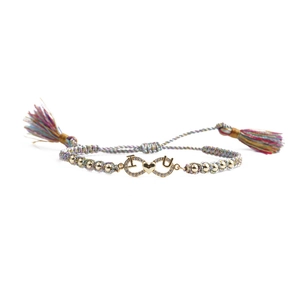 Detail of adjustable colorful woven bracelet with gold infinity symbol and I Love U charm