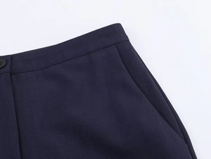 Close-up of deep blue trouser waist showing premium twill fabric and button stitching detail