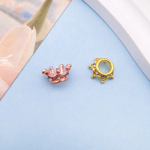 Close-up of crown jewelry beads with colorful rhinestones in gold and rose gold finish