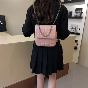 Pink quilted PU leather small square chain backpack with heart buckle shown on model back