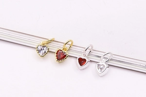 Detailed macro view of S925 silver heart pendants with red and white zirconia