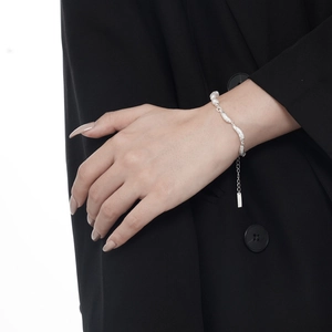 Irregular silver textured bracelet for women featuring white pearls and adjustable chain