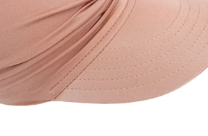 Close-up of pink sun visor showing fine fabric texture and neat parallel stitching
