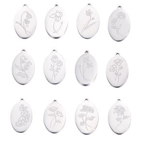 Detailed macro view of twelve silver oval pendants featuring different engraved birth flowers