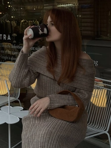 Detail of off-the-shoulder ribbed knit long sleeve dress with premium brown suede handbag
