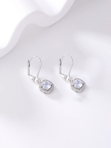 Detail view of round cubic zirconia earrings in a silver halo setting with ear hooks