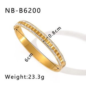 Detail view of gold-plated stainless steel bangle with inlaid crystals and secure clasp