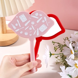 Close-up of pink and red lip-shaped hand-held makeup mirrors with plastic frames