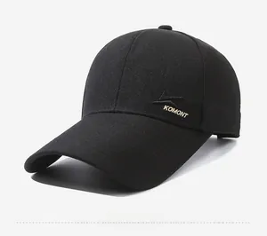 Detail shot of black baseball cap featuring premium KOMONT embroidery on side profile