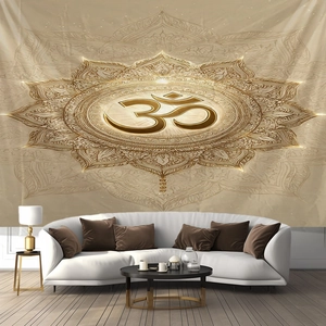 Detail of a beige mandala tapestry with a golden Om symbol hanging over a modern white sofa