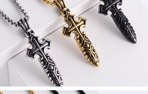 Macro view of Gothic cross pendants in silver, gold, and black with skull motifs