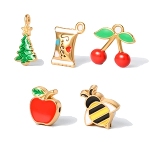 Detail of colorful enamel Christmas pendants including tree, candy and apple shapes