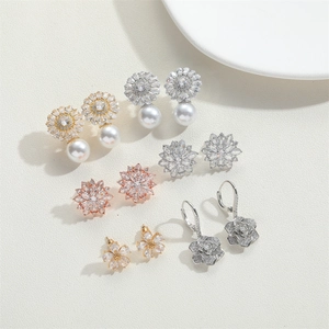 Flat lay of luxury vintage flower earrings with pearls and cubic zirconia stones