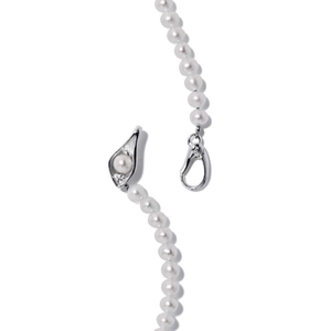 Detail of 925 sterling silver pea pod clasp and white faux crystal pearls on necklace