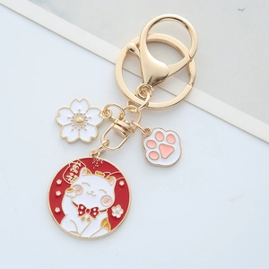 Japanese Maneki Neko keychain with cherry blossom, cat paw charms and lucky bell